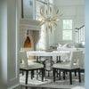 Dahlia Chandelier in Gold haniging over dining table, hubbardton forge