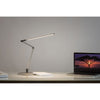 z-bar slim led desk lamp by koncept lighting on a white desk lighting a laptop