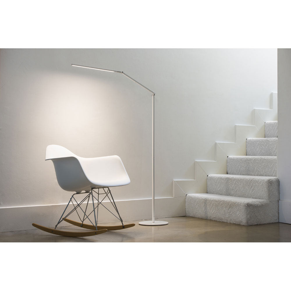 White Z-bar LED Floor lamp from Koncept lighting,  lighting rocking chair at bottom of stairs