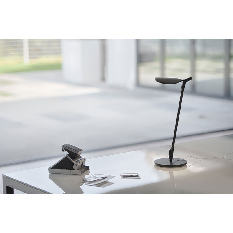 Matte black Splitty Pro LED desk lamp on table lighting polaroid pictures
