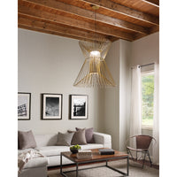 syrma grande pendant in satin gold hanging over coffee table in living room
