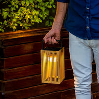Illuminate your outdoor spaces with the Okinawa Lantern, a handmade bamboo lamp, with a rechargeable bulb, providing up to 20 hours of light.
